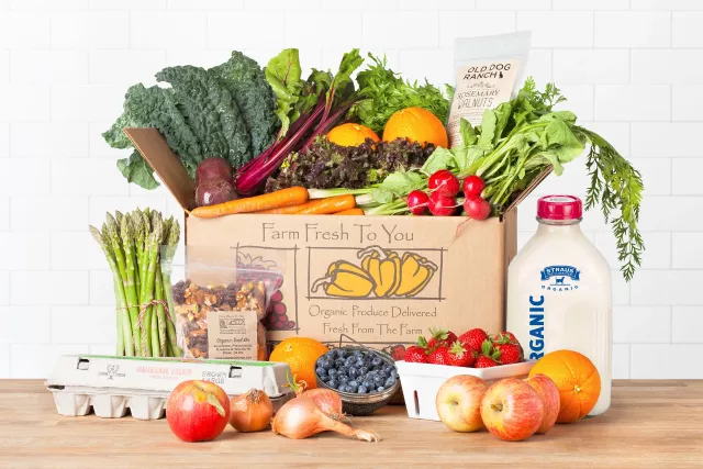 family size fresh produce box assortment Kenyan vegetables and fruits on wooden table